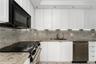 White shaker-style cabinetry, stone countertops with matching full-height backsplash, undermount sink with arched faucet, stainless steel appliances, 