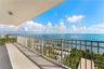 Covered balcony featuring a metal railing, concrete flooring, and an overhead flush-mount light fixture