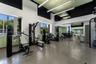 Fitness center featuring high ceilings with integrated linear lighting, large windows, mirrored walls, and durable resilient flooring