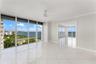 Floor-to-ceiling windows, white tile flooring, ceiling fan, and crown molding