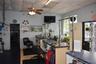 Drop ceiling with integrated lighting, ceiling fan, and built-in service counter