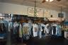 Commercial interior featuring mechanical garment conveyor systems and wall-mounted administrative signage