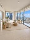 Floor-to-ceiling windows, porcelain tile flooring, structural column, and an expansive balcony
