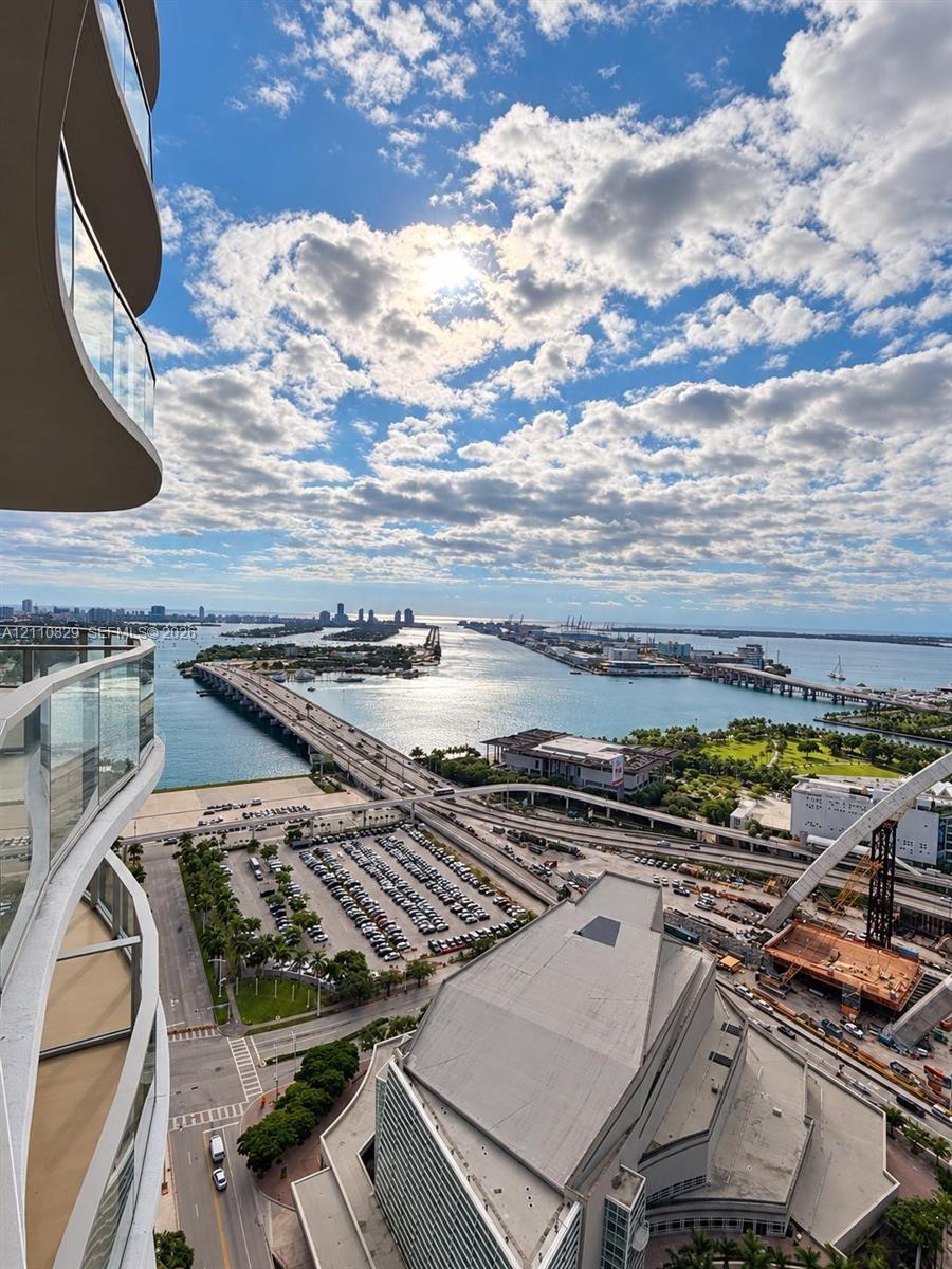 High-rise balcony featuring glass railings and a curvilinear architectural profile