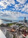 Elevated high-rise perspective featuring panoramic water, bridge, and cityscape scenery
