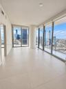 Floor-to-ceiling glass windows, ceramic tile flooring, wraparound balcony access, and structural column