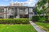 Screened lanai, concrete walkway and manicured landscaping