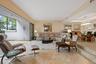 Large-format retractable sliding glass doors, tile flooring, recessed lighting, and a multi-tiered interior layout