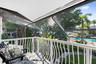 Screened-in balcony in primary bedroom featuring a white metal railing and a solid roof covering