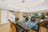 Tray ceiling with recessed lighting, tile flooring, and retractable glass sliding doors