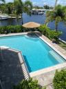 Waterfront swimming pool with paver decking and integrated step entry