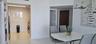 Large-format white tile flooring, stacked laundry appliance enclosure, and contemporary architectural lighting fixture