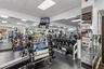 Fitness facility featuring mirrored walls, rubberized flooring, and built-in weight storage racks