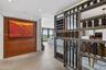 Custom metal wood and other materials room divider, wood-paneled wall feature, large-format tile flooring, and recessed ceiling lighting