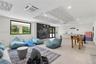 Spacious interior featuring recessed lighting, decorative ceiling acoustic panels, large-format tile flooring, a dark textured accent wall, and built-