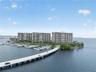 Waterfront high-rise community featuring a private marina, paved causeway access, and established tropical landscaping