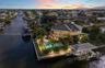 Waterfront property featuring a private swimming pool, multi-level exterior decking, and a dedicated boat dock