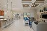 Open-concept layout featuring a coffered ceiling, recessed lighting, tile flooring, built-in entertainment cabinetry, and a kitchen island with pendan