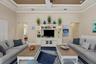 Tray ceiling with crown molding, built-in white entertainment center, and plantation shutters