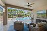 Covered lanai featuring paver flooring, a recessed ceiling with a central fan, and a screened enclosure surrounding a swimming pool