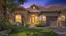 Exterior featuring stone veneer siding, tile roof, arched entryway with double doors, and paved driveway