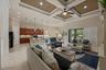 Open-concept interior featuring a coffered ceiling, recessed lighting, tile flooring, and custom cabinetry with an integrated breakfast bar