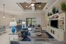 Coffered ceiling with recessed lighting, central ceiling fan, built-in floor-to-ceiling media cabinetry, tile flooring, and sliding glass doors