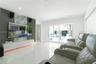 Polished stone-finish flooring, custom accent wall featuring vertical slats and a natural stone-finish inset, integrated low-profile cabinetry with un