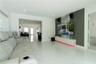 Living area featuring polished tile flooring, a wall-mounted floating media cabinet, and a decorative accent wall with vertical slat paneling and ston