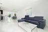 Large-format porcelain tile flooring, recessed ceiling lighting, and dual-layered window shades
