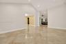 Vaulted ceilings featuring recessed lighting and polished stone-finish tile flooring