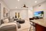 Vaulted ceilings, recessed lighting, double French doors, and stone-finish flooring