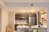 Kitchen featuring dark wood-finish cabinetry, stainless steel appliances, quartz countertops, a central island, and modern multi-bulb overhead lightin
