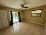 Interior space featuring tile flooring, a ceiling fan, and access to an outdoor pool area through sliding glass doors