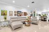 Open-concept floor plan featuring light-toned tile flooring, recessed lighting, and crown molding