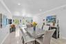 Open-concept interior featuring large-format tile flooring, recessed lighting, and crown molding