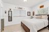 Open-concept interior featuring large-format tile flooring, recessed ceiling lighting, crown molding, and expansive windows with installed blinds
