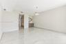 Expansive room featuring polished stone flooring, built-in cabinetry with a stone countertop, custom walk-in closet shelving, and a modern drum pendan