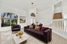 Impressive formal living room with dramatic vaulted ceilings, oversized arched windows, and an open, airy design that creates a wonderful first impres