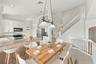 An inviting kitchen and breakfast area featuring white cabinetry, generous counter space, and an open design that connects seamlessly to the surroundi