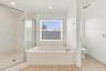 Enjoy the convenience of a separate soaking tub and oversized glass-enclosed shower, offering the perfect combination of comfort and functionality.