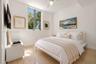 Bright room featuring wood-finish flooring, a vertical window, and a ceiling fan with integrated lighting