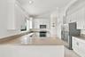 Generous countertop space, abundant cabinetry, and a practical U-shaped layout make this kitchen ideal for meal preparation, entertaining, and everyda