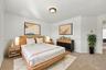 With its generous proportions, neutral carpeting, and decorative wall details, this bedroom offers flexibility for guests, family, or a home office.