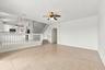 The generous formal living room offers soaring ceilings, an elegant chandelier, and an open design overlooking the home's grand entryway.