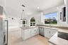 An expansive breakfast bar provides additional seating and preparation space, while the kitchen's open design allows for effortless interaction with t