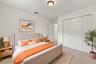 A versatile main-level bedroom offering generous closet space, neutral finishes, and a practical layout ideal for guests or a home office.