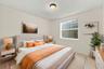 This well-appointed main-level bedroom offers flexibility for guests, a private office, or additional living space, with convenient access to the home