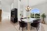 An elegant chandelier, soaring ceilings, and an open connection to the adjacent living areas create a wonderful setting for entertaining.