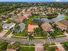 An elevated perspective highlighting the home's beautiful waterfront location within the desirable Boca Isles South community.